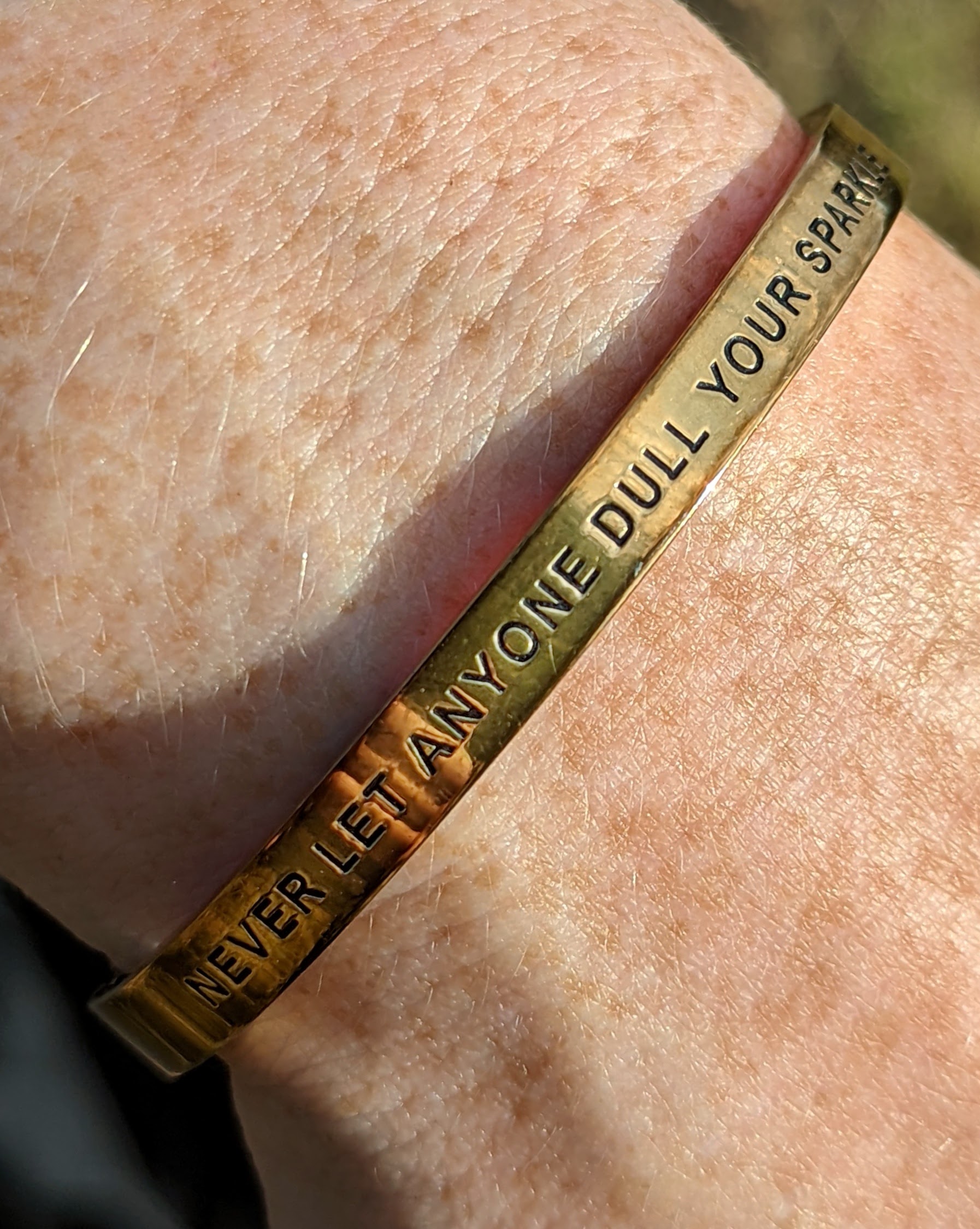 Carey's offering to the project, a bright copper coloured bracelet with words engraved saying "Never let anyone dull your sparkle".