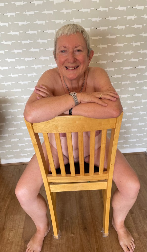 Sarah naked, on a chair.