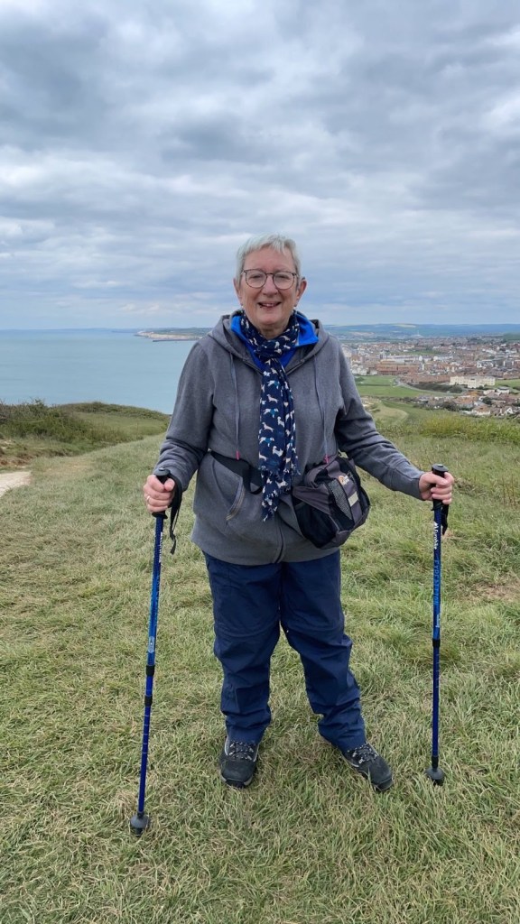 Sarah standing with hiking poles.