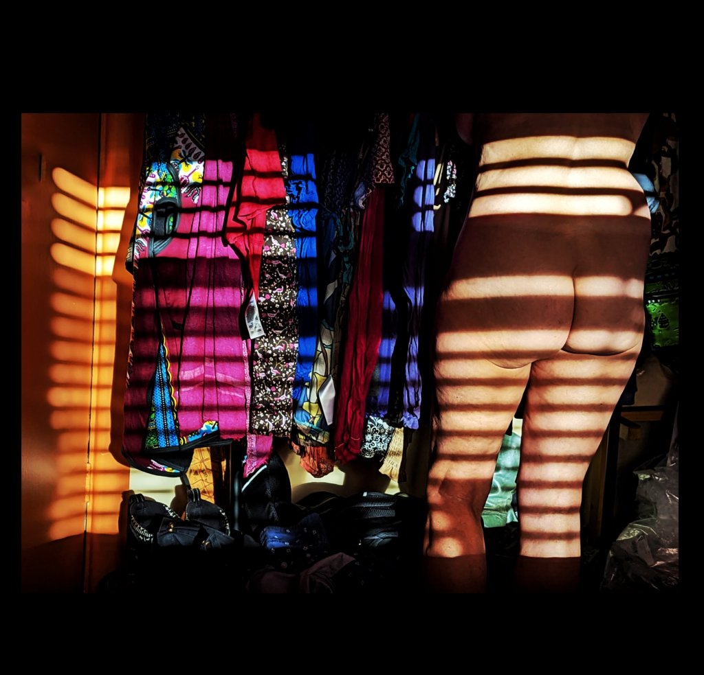 Shadow stripes over clothing and a naked back.