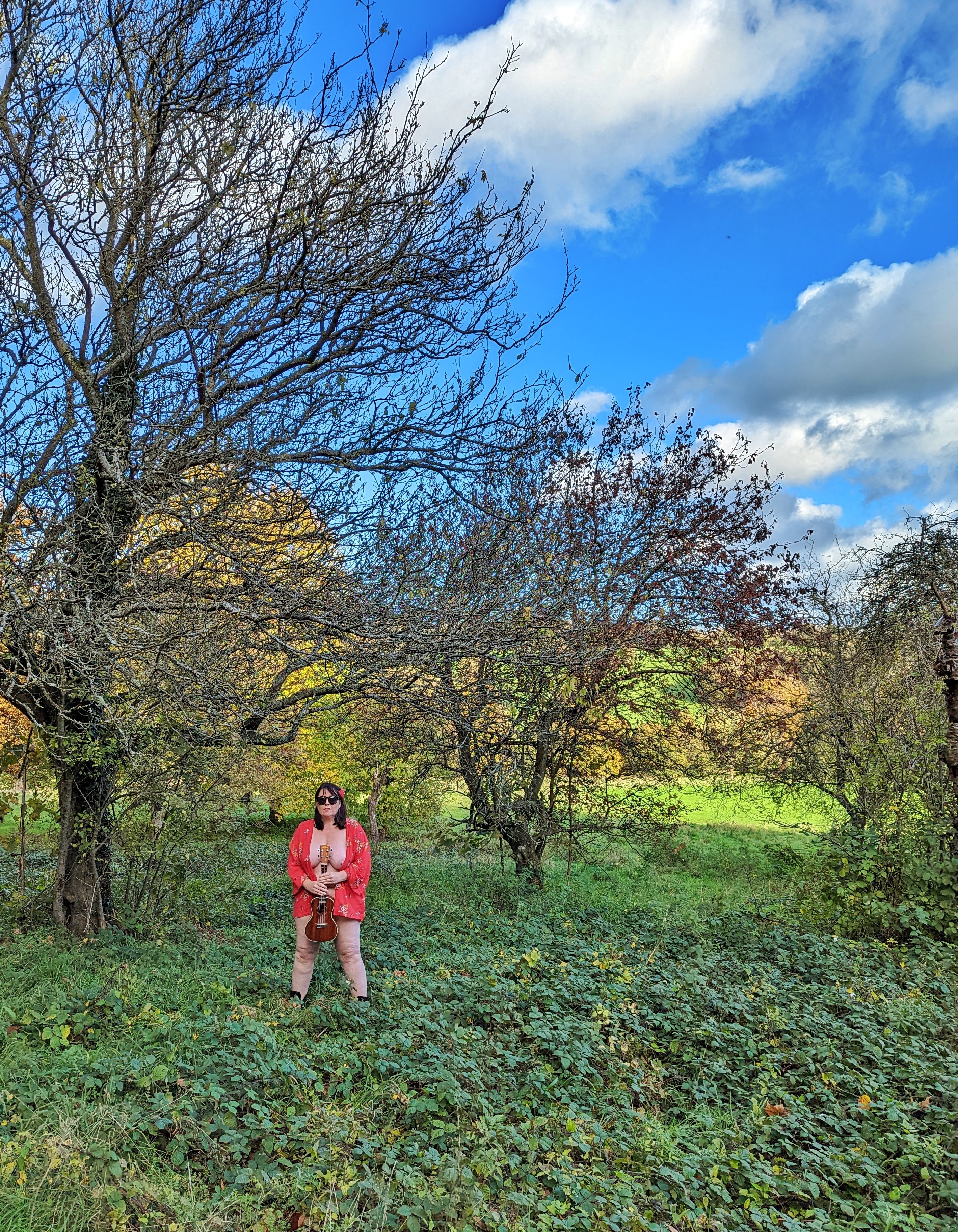 Liz standing naked with a uke